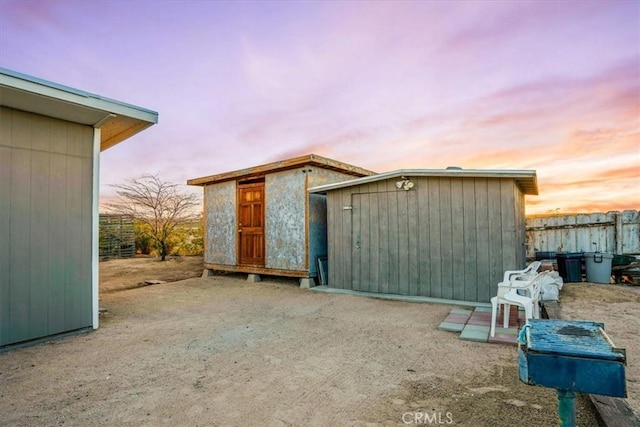 63854 Orion Rd, Joshua Tree, CA 92252 - outdoor structure at dusk with a storage unit