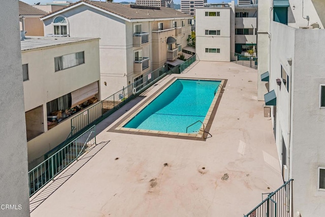 community pool with a patio area