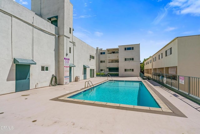 pool with fence and a patio area