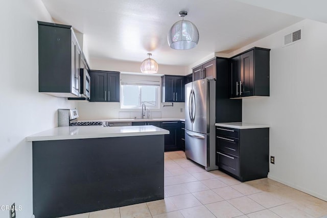 500 Jackson Pl Unit 313, Glendale, CA 91206 - kitchen featuring appliances with stainless steel finishes, a sink, a peninsula, light countertops, and hanging light fixtures