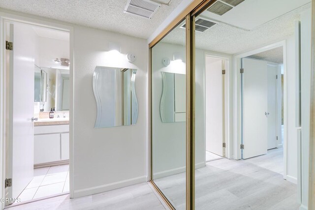 500 Jackson Pl Unit 313, Glendale, CA 91206 - bathroom featuring wood finished floors, a textured ceiling, and vanity