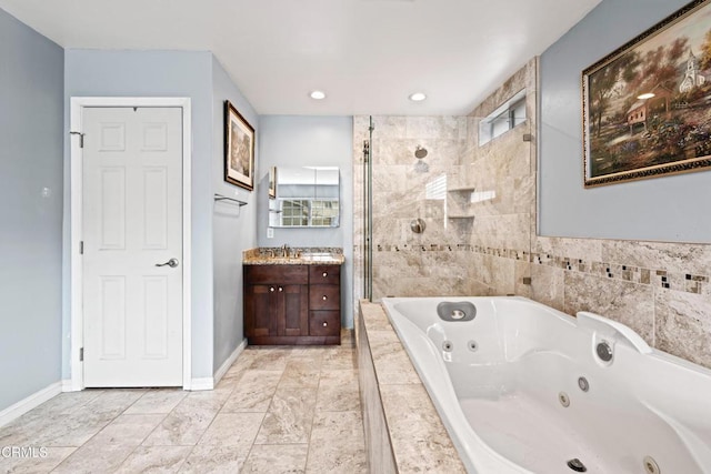 1257 S G St, Oxnard, CA 93033 - full bath featuring a tile shower, vanity, a jetted tub, recessed lighting, and baseboards
