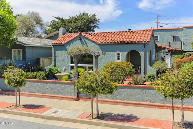 mediterranean / spanish-style house with a tile roof and stucco siding