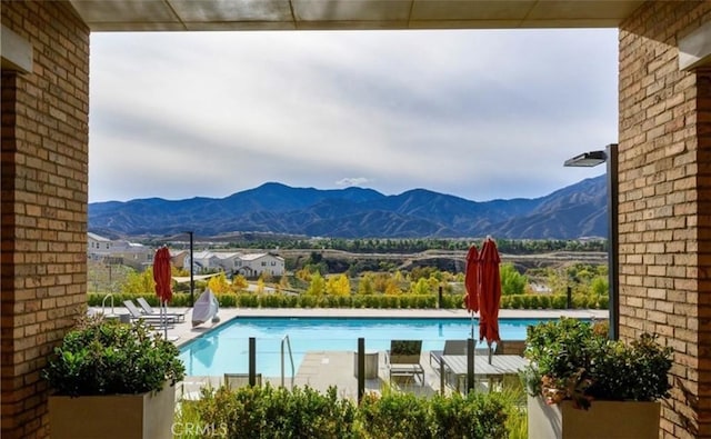 community pool with a mountain view