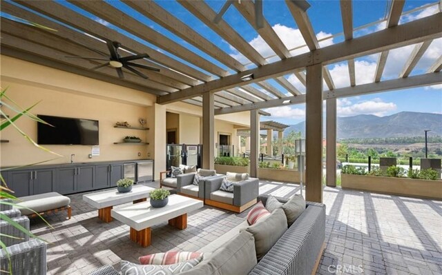 24845 Elison Ct, Corona, CA 92883 - view of patio featuring an outdoor hangout area, a pergola, a mountain view, exterior kitchen, and a ceiling fan