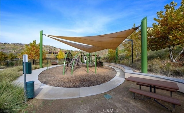 view of home's community featuring fence and playground community
