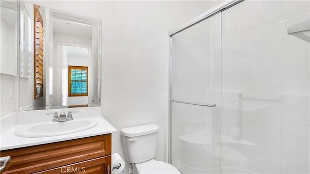 full bathroom featuring an enclosed shower, toilet, and vanity