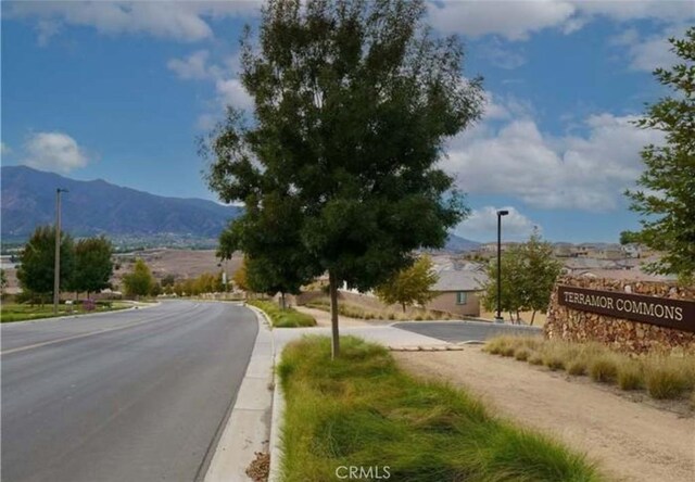 24845 Elison Ct, Corona, CA 92883 - view of asphalt road with a mountain view, curbs, and street lighting