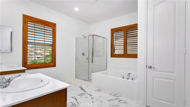 bathroom with a stall shower, recessed lighting, a garden tub, vanity, and marble finish floor