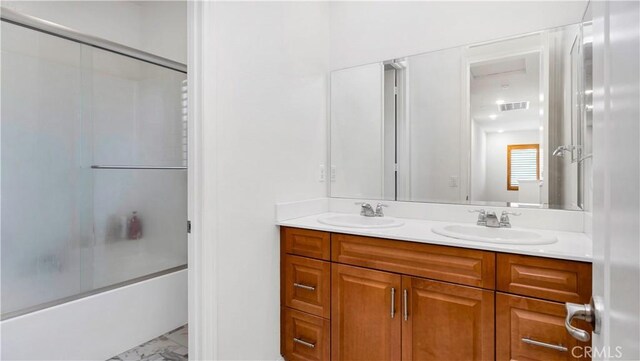 24845 Elison Ct, Corona, CA 92883 - bathroom featuring marble finish flooring, double vanity, and enclosed tub / shower combo
