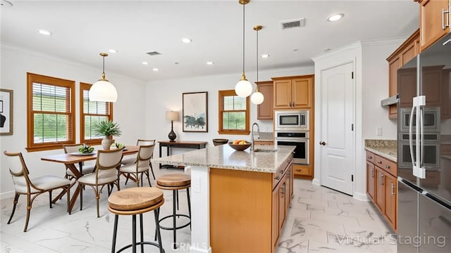 24845 Elison Ct, Corona, CA 92883 - kitchen featuring appliances with stainless steel finishes, light marble finish floors, brown cabinetry, recessed lighting, and light stone counters