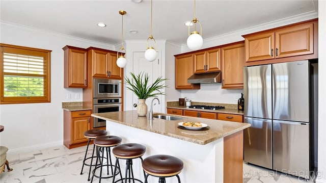 24845 Elison Ct, Corona, CA 92883 - kitchen featuring stainless steel appliances, a sink, under cabinet range hood, brown cabinetry, and light stone countertops