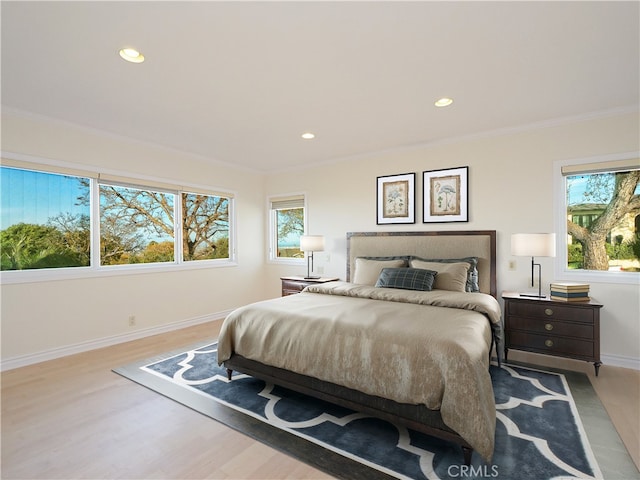 bedroom with crown molding, baseboards, recessed lighting, and wood finished floors