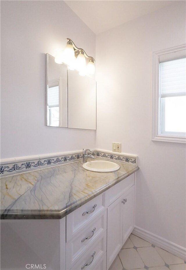 bathroom featuring vanity and baseboards