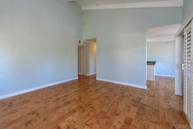 17159 W Bernardo Dr Unit 202, San Diego, CA 92127 - spare room featuring baseboards, visible vents, high vaulted ceiling, and wood finished floors