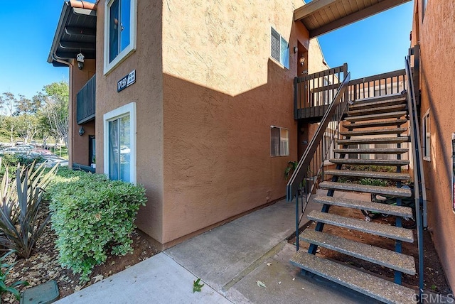 17159 W Bernardo Dr Unit 202, San Diego, CA 92127 - view of side of property with stucco siding and stairway