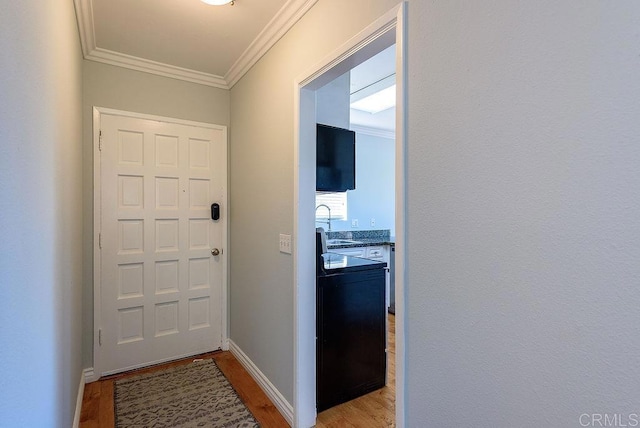 17159 W Bernardo Dr Unit 202, San Diego, CA 92127 - doorway to outside with light wood-style floors, crown molding, and baseboards