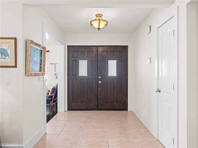 foyer entrance with baseboards and light tile patterned flooring