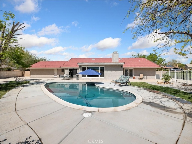 view of swimming pool with fence, a fenced in pool, and a patio