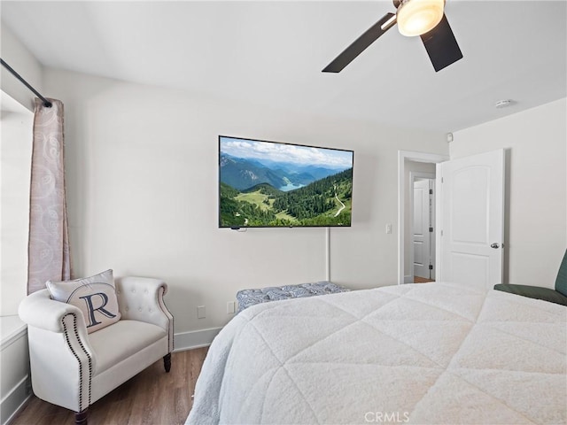 bedroom with wood finished floors, baseboards, and a ceiling fan