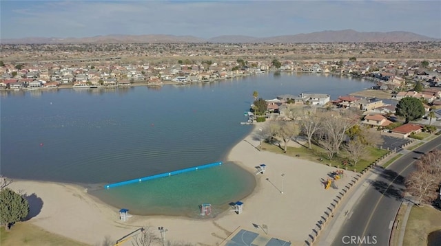 birds eye view of property featuring a water and mountain view and a residential view