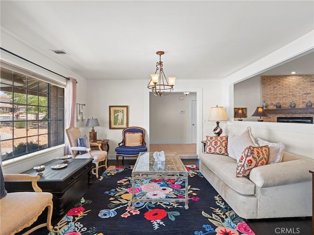 living room featuring visible vents, baseboards, and a notable chandelier