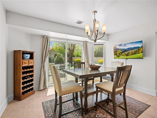 dining space featuring plenty of natural light, light tile patterned floors, visible vents, and baseboards