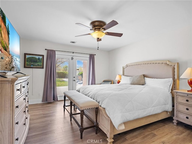 bedroom featuring access to outside, visible vents, french doors, and wood finished floors