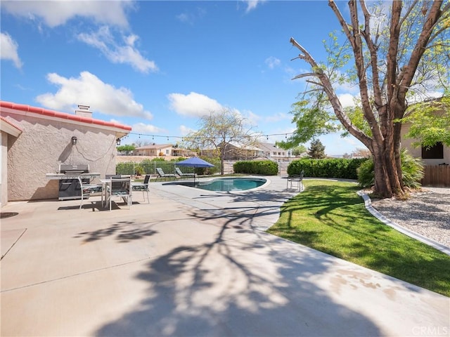 view of swimming pool with a yard, grilling area, fence, a patio, and a fenced in pool