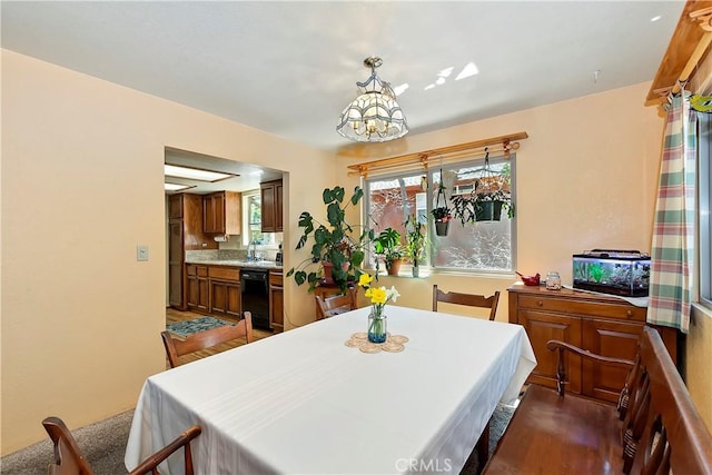 dining room featuring dark wood-style flooring, an inviting chandelier, and a wealth of natural light