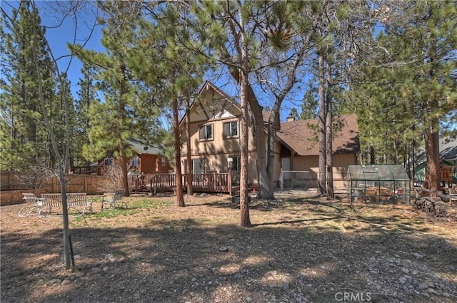 view of yard with a wooden deck and fence