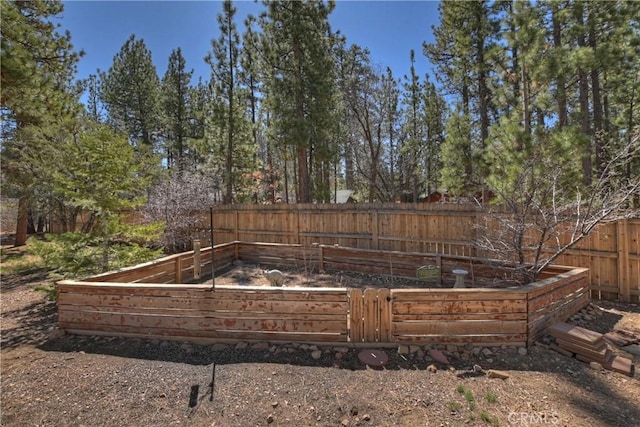 view of yard with a fenced backyard and a vegetable garden