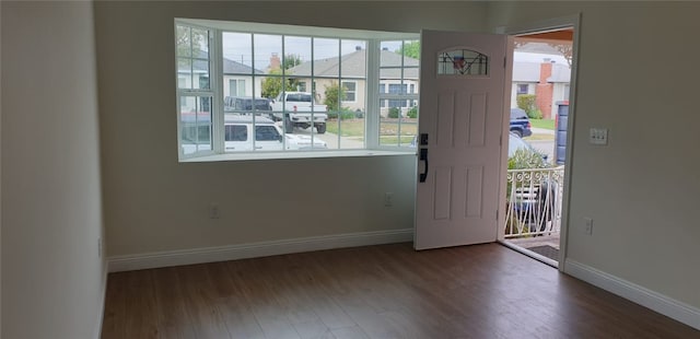 interior space featuring baseboards and wood finished floors