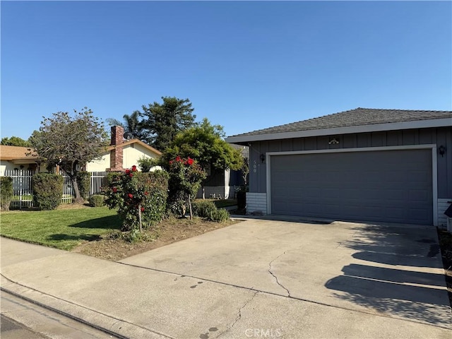 view of front facade with an attached garage, board and batten siding, fence, and concrete driveway