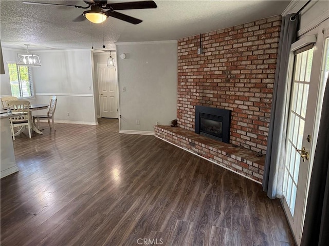 500 Sherri Way, Turlock, CA 95382 - unfurnished living room with a fireplace, a ceiling fan, dark wood finished floors, a textured ceiling, and crown molding