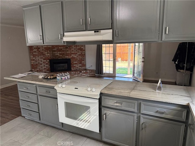 500 Sherri Way, Turlock, CA 95382 - kitchen with electric stove, gray cabinetry, under cabinet range hood, ornamental molding, and baseboards