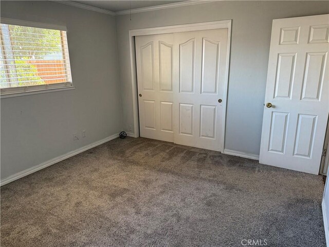 500 Sherri Way, Turlock, CA 95382 - unfurnished bedroom featuring carpet floors, crown molding, a closet, and baseboards