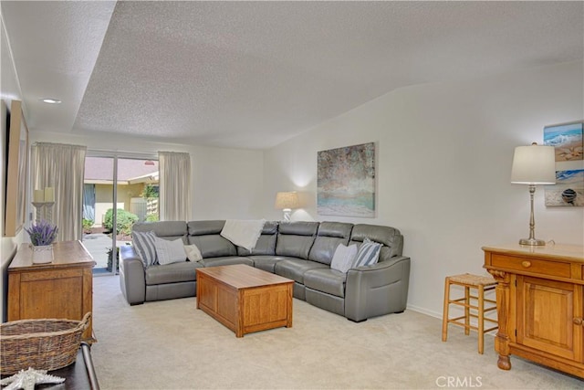 living room featuring light carpet, lofted ceiling, and a textured ceiling
