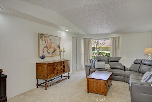 living area with light carpet, a textured ceiling, and vaulted ceiling