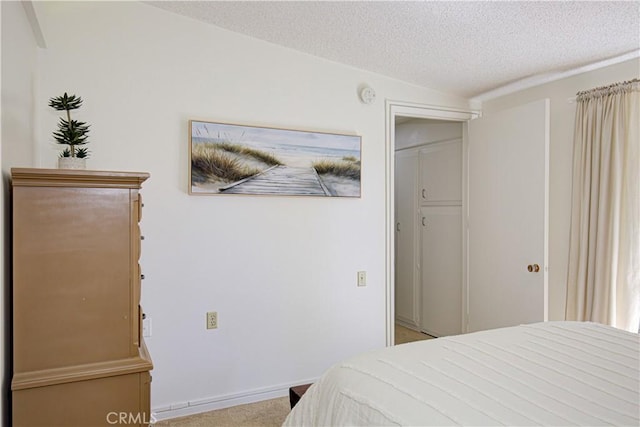 carpeted bedroom with a textured ceiling