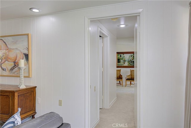 corridor with light carpet and baseboards