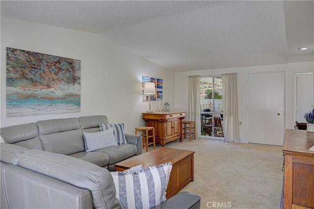 living room featuring light colored carpet, a textured ceiling, and lofted ceiling