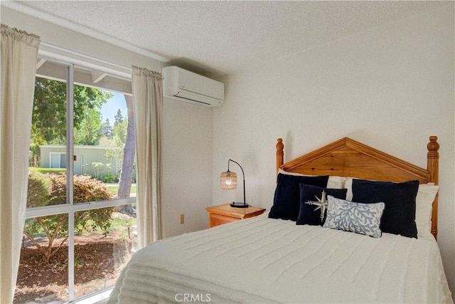 bedroom featuring a textured ceiling and an AC wall unit