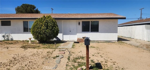 ranch-style house with stucco siding