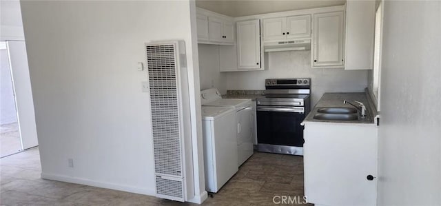 kitchen featuring stainless steel electric range oven, under cabinet range hood, a sink, a heating unit, and washer and dryer