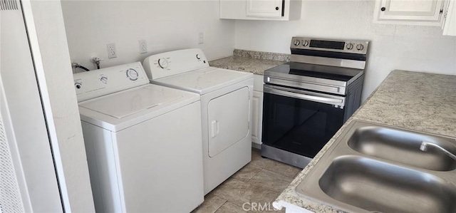 laundry room featuring separate washer and dryer, laundry area, and a sink