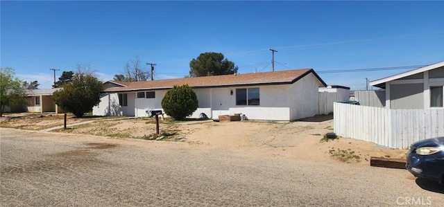 ranch-style house with fence