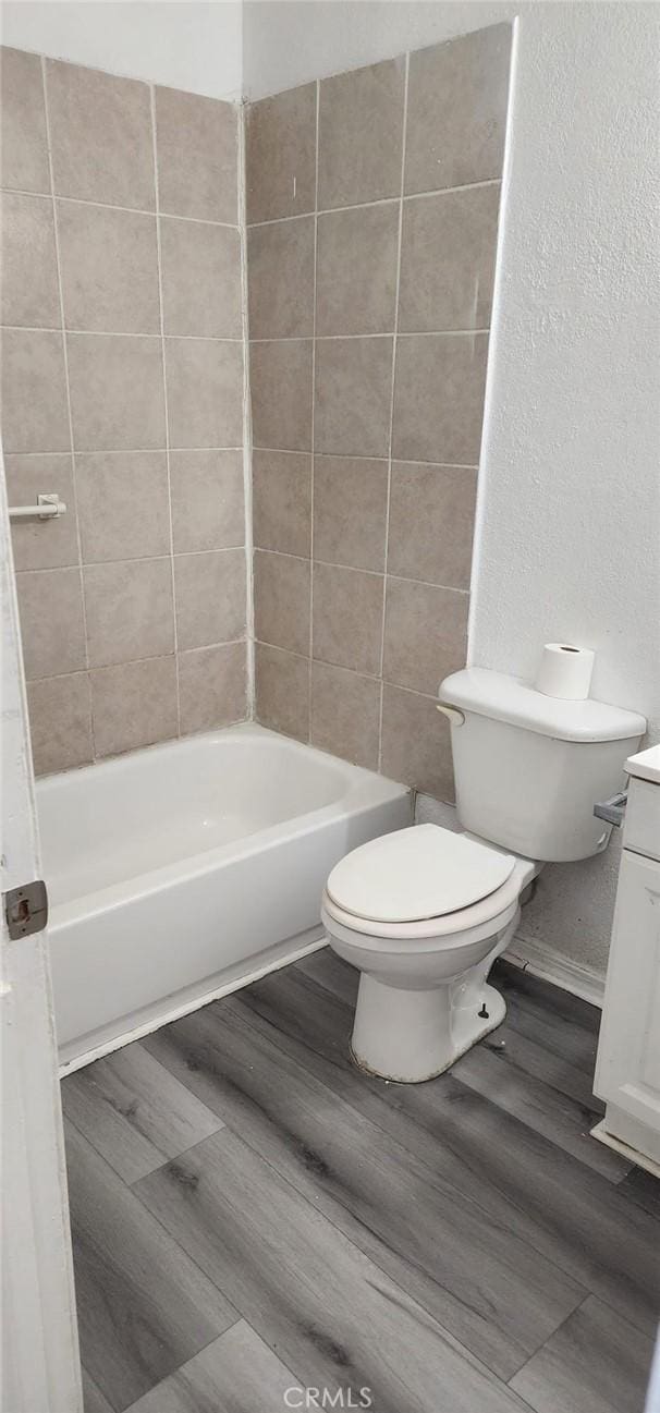 full bathroom with toilet and wood finished floors