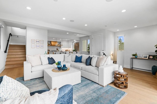 living room featuring stairway, wood finished floors, recessed lighting, and baseboards