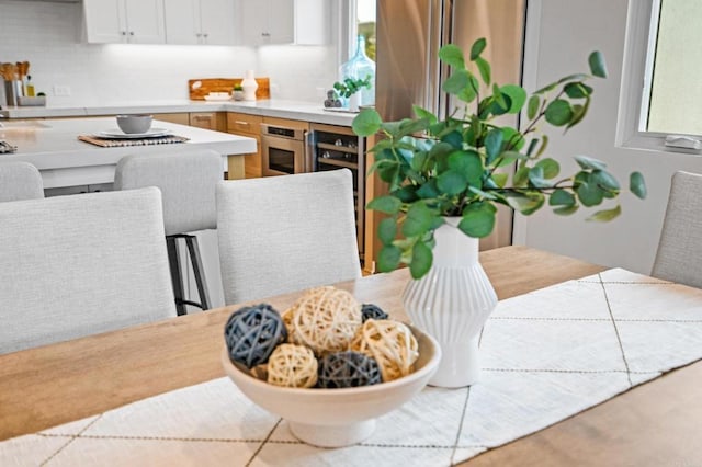 kitchen featuring oven, white cabinetry, and light countertops